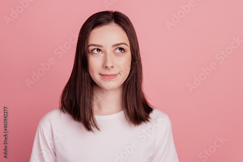 Portrait of nice attractive girl happy positive smile wondered minded look empty space isolated over pink color background