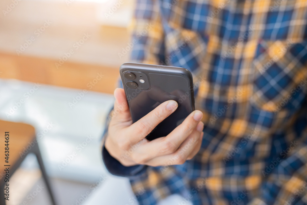 using cell phone hand holding mobile texting message contact us.chatting,search internet information in office.technology device communication connecting using cell phone hand holding mobile texting message contact us.chatting,search internet information in office.technology device communication connecting