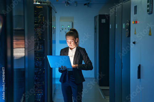 IT engineer specialist working in network server room photo