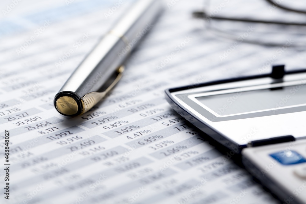 Calculator and Pen on Financial Figures Calculator and Pen on Financial Figures