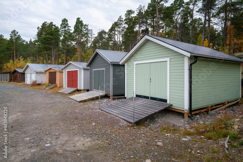 Colorful wooden houses to keep the boats in on the lake shore. Stora Sjofallet National Park, Sweden. © Petr