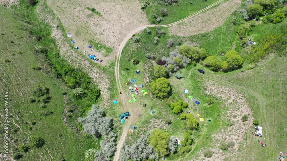 Aerial view camping area, Many, different tents on green. Touristic place. Resting area. Hiking place. Aerial view camping area, Many, different tents on green. Touristic place. Resting area. Hiking place.
