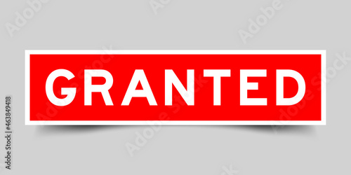 Sticker label with word granted in red color on gray background