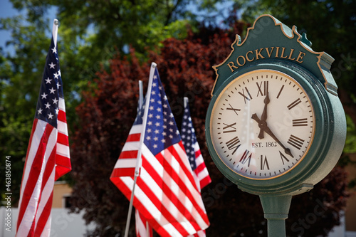 Vintage metal clock and American flags in a small town. Rockville, Utah. photo