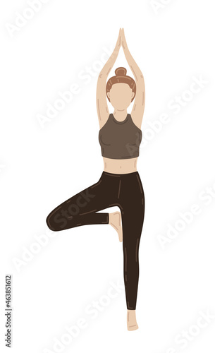 Young slim woman doing yoga exercise. Vrikshasana, tree pose