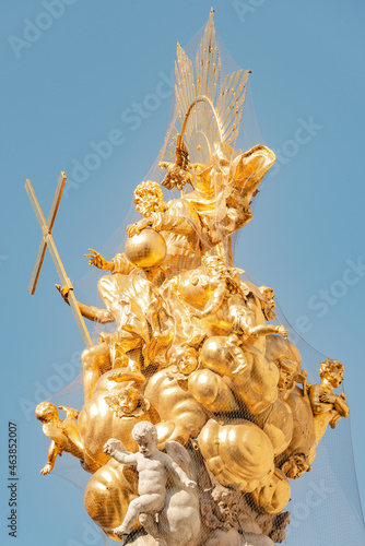 Top golden baroque sculptures of Column of Holy Trinity which commemorate victims of the plague epidemics in 1679 located in Graben, historical downtown of Vienna, Austria.