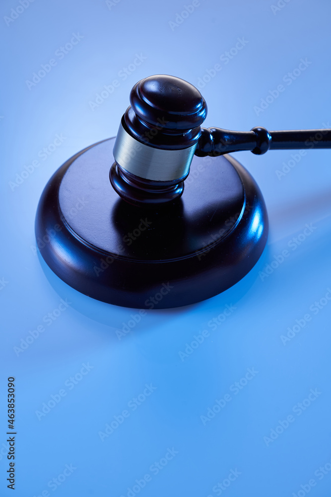 wooden judge gavel and soundboard isolated on blue background wooden judge gavel and soundboard isolated on blue background