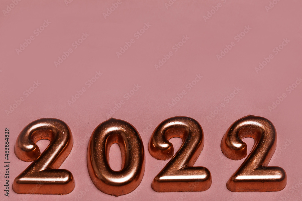 Festive New year and Christmas golden number 2022 on pink background Festive New year and Christmas golden number 2022 on pink background