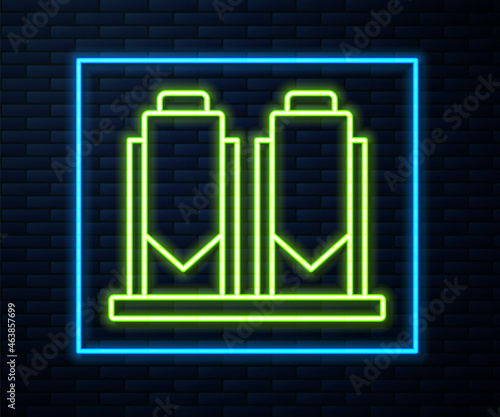 Glowing neon line Traditional brewing vessels in brewery icon isolated on brick wall background. Beer brewing process. Distillery plant, brewery. Vector