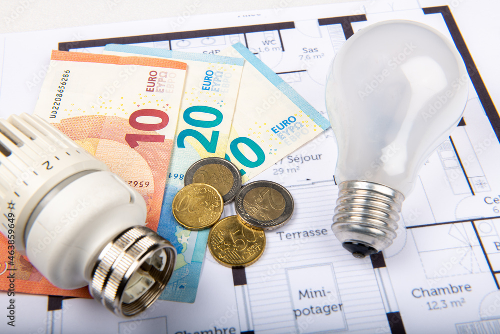 Energy saving concept house plan, money, thermostat and bulb in France Energy saving concept house plan, money, thermostat and bulb in France