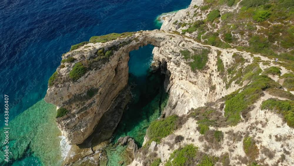Aerial drone video of paradise exotic rocky arch with emerald crystal clear sea in tropical island destination Aerial drone video of paradise exotic rocky arch with emerald crystal clear sea in tropical island destination