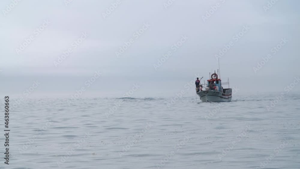 Fishing Boat approaching shore with misty background Fishing Boat approaching shore with misty background