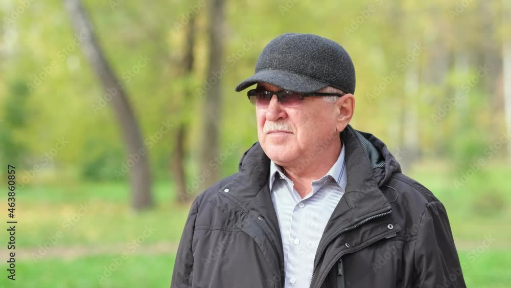 Senior man with a mustache in the park. portrait of a gray-haired man in a shirt and black jacket. Senior man with a mustache in the park. portrait of a gray-haired man in a shirt and black jacket.