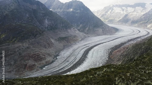 Aerial shows Aletschglacier and a bird passes by, Switzerland photo