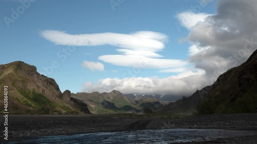 Timelaps of a valley with cars crossing a river and driving away photo