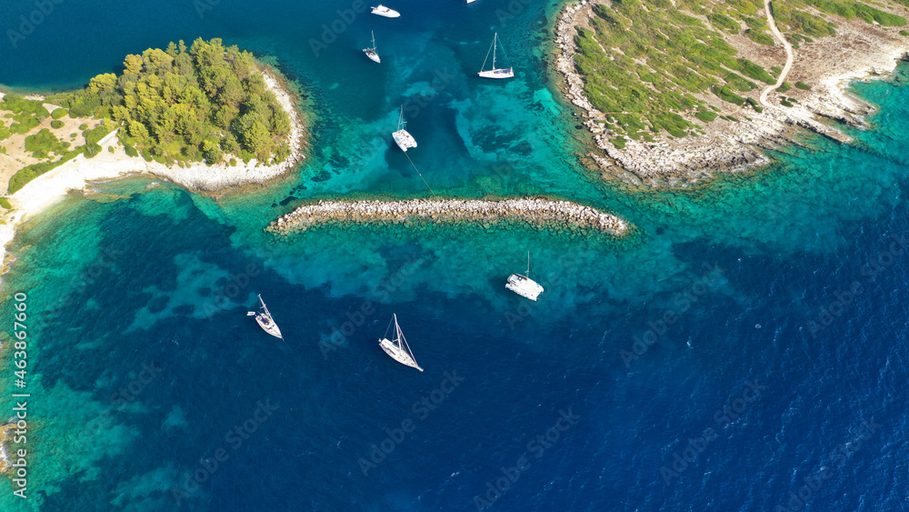 Aerial drone photo of turquoise paradise bay visited by yachts and sail boats in Caribbean island destination