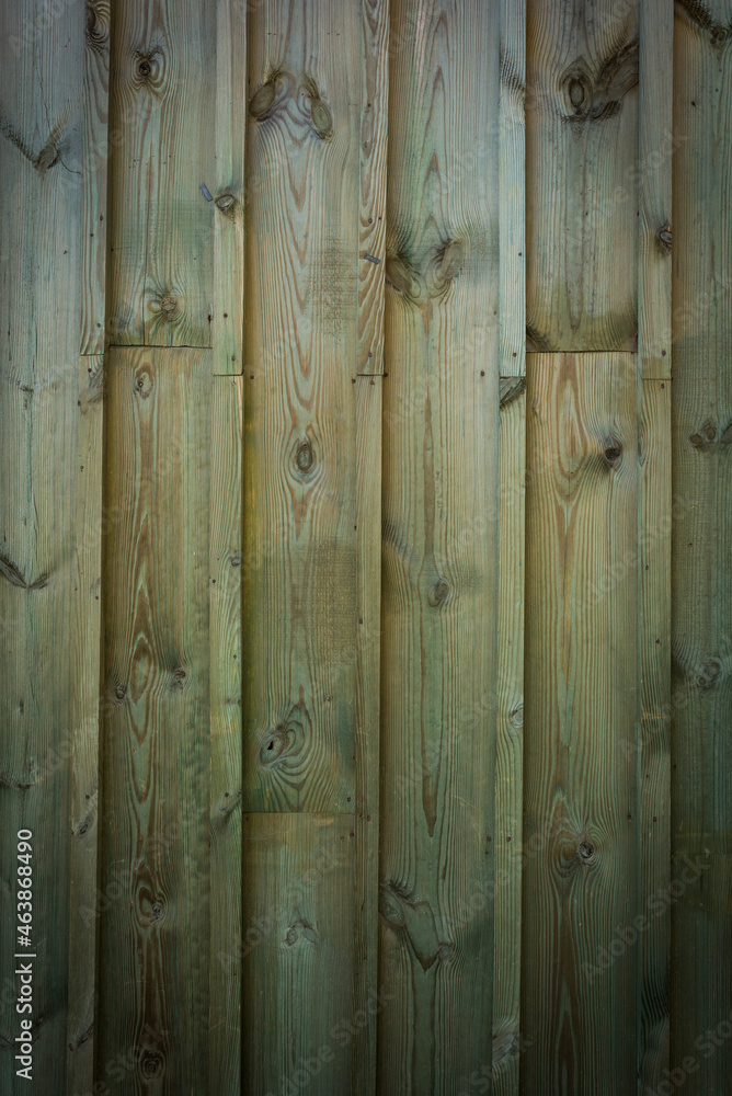 Fototapeta premium Wooden logs of an old house. Close-up. Weathered natural gray wood texture. Background. vertical photo.