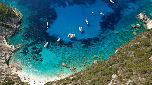 Fototapeta Naklejka Na Ścianę i Meble -  Aerial drone photo of iconic paradise bay and rocky beach of Erimitis in island of Paxos visited by luxury yachts and sail boats, Ionian, Greece