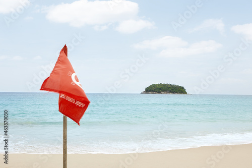 View of warning flag on nice warm tropic beach during law season photo