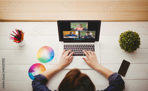 Caucasian woman using laptop for video call, with diverse elementary school pupils on screen