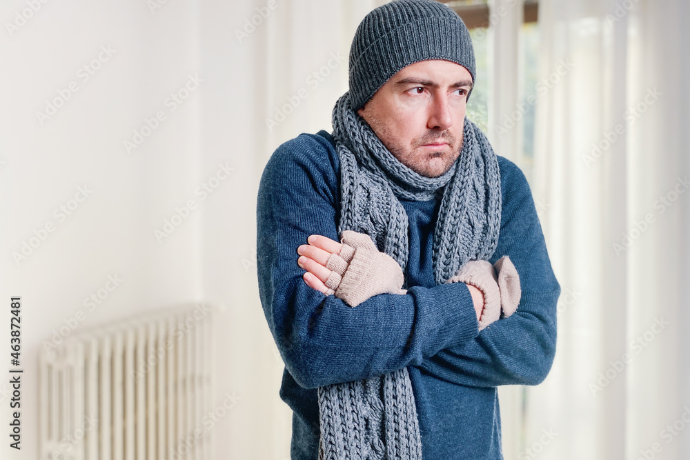 Foto de Man feeling cold at home with home heating trouble do Stock ...