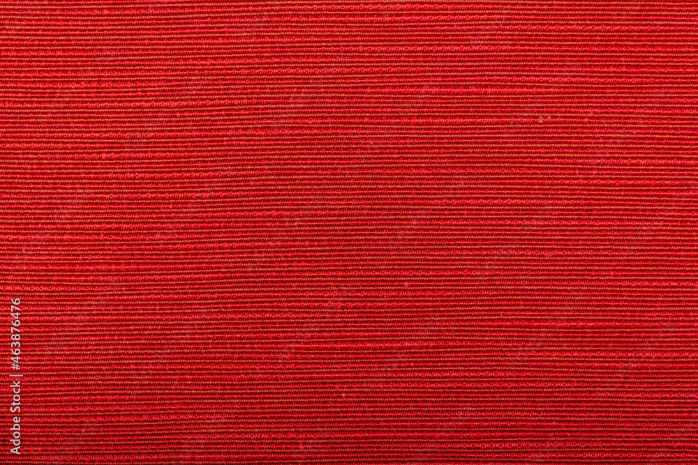 Fototapeta premium Factory fabric of red color . Close-up long and wide texture of natural red fabric. Fabric texture of natural cotton or linen textile material. Red canvas background