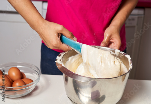 a woman kneads the mixture to make a cake