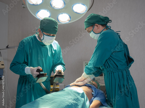 Obraz na plátně Doctors give resuscitation to a male patient in the operation room, rescue safe