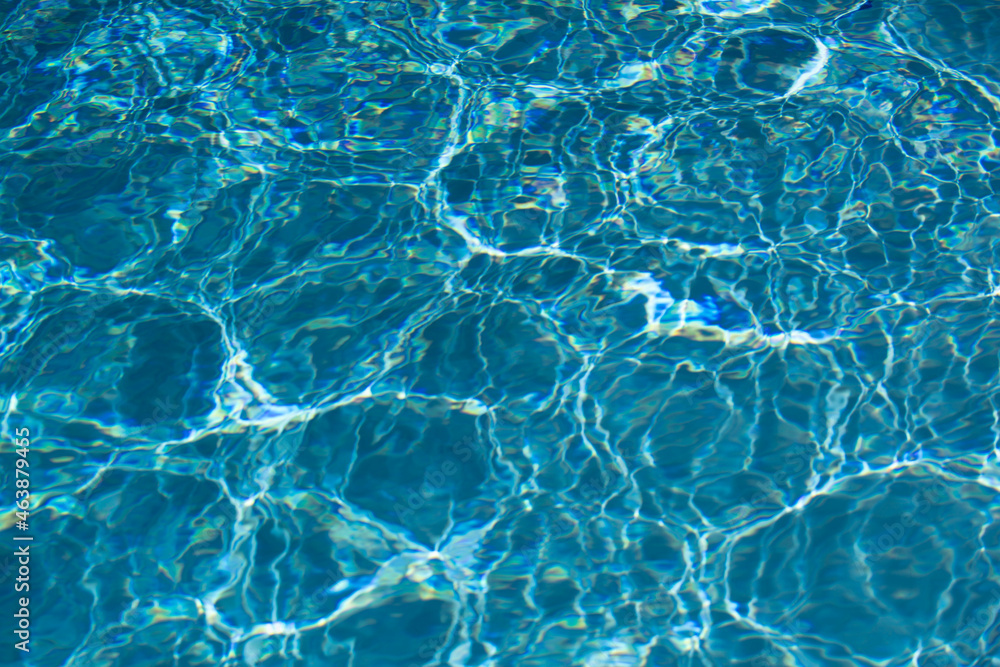 Naklejka premium Background of blue water in swimming pool with sun reflection, ripple water wave in pool. Clear water background.