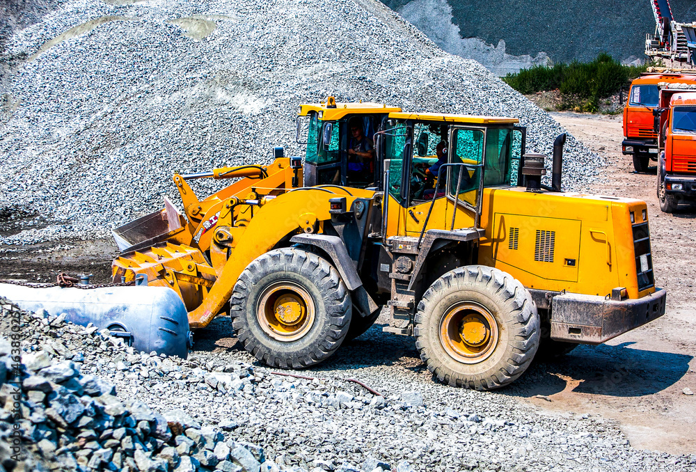 Yellow bulldozers working in quarry construction Yellow bulldozers working in quarry construction