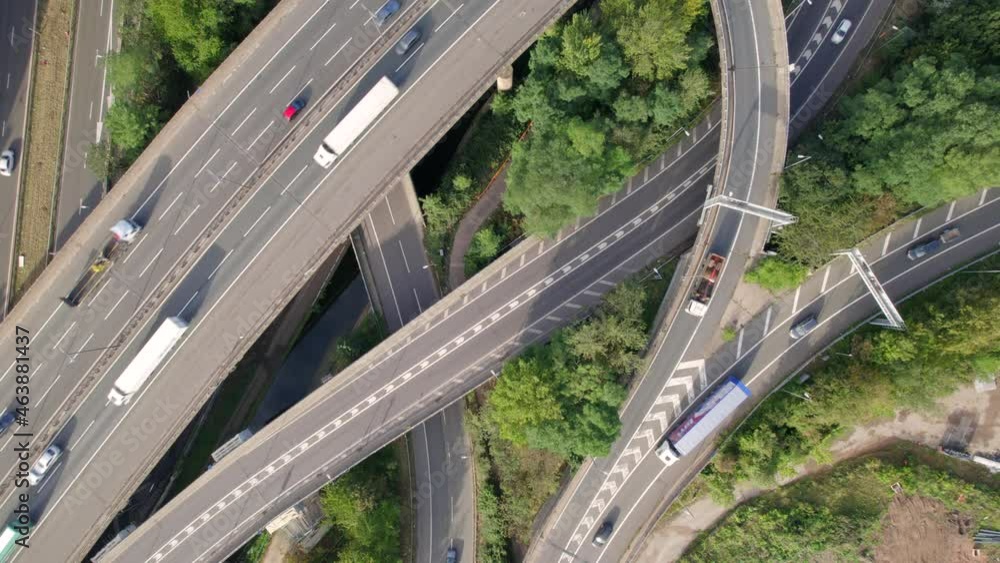 Vehicles Driving on a Spaghetti Interchange Bird's Eye Aerial View Vehicles Driving on a Spaghetti Interchange Bird's Eye Aerial View