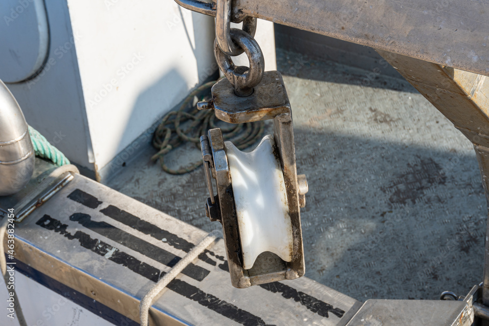 Close-up with selective focus of a pulley, on a fishing boat. Close-up with selective focus of a pulley, on a fishing boat.
