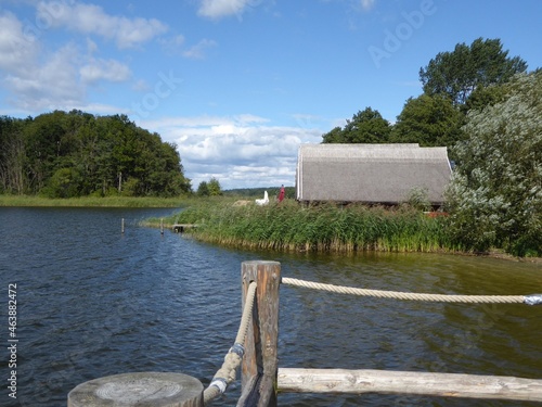 Bathing jetty and thatched-roof boathouses at Mirow Lake, Granzow, Mecklenburg-Western Pomerania, Germany photo