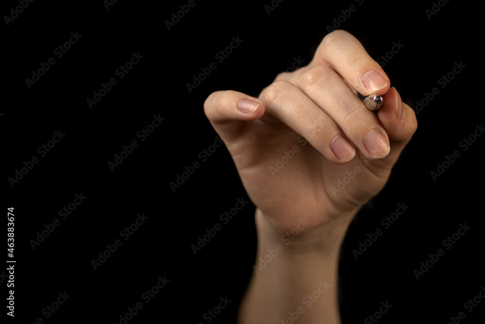 Hand is holding pen isolated on black background, pointing idea, make a note concept, copy space photo Hand is holding pen isolated on black background, pointing idea, make a note concept, copy space photo