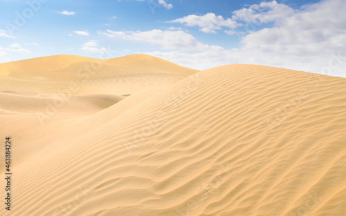 Picturesque view of sandy desert and blue sky on hot sunny day