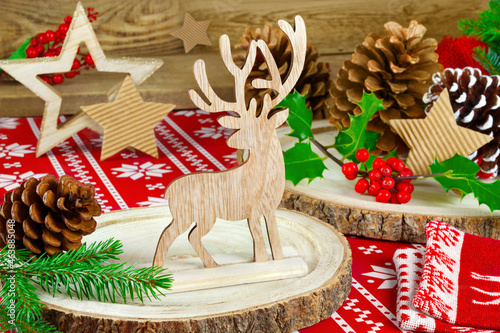 Natural wooden Christmas decoration with reindeer and fir branches photo