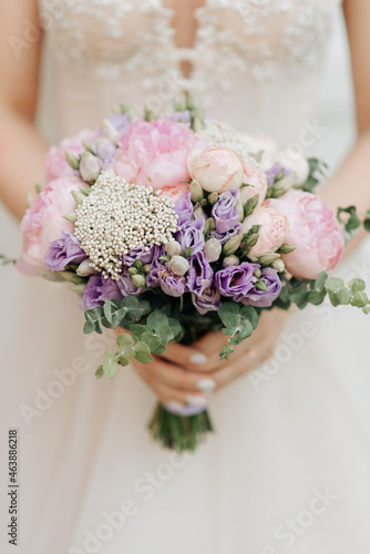 bridal bouquet holding a white wedding dress