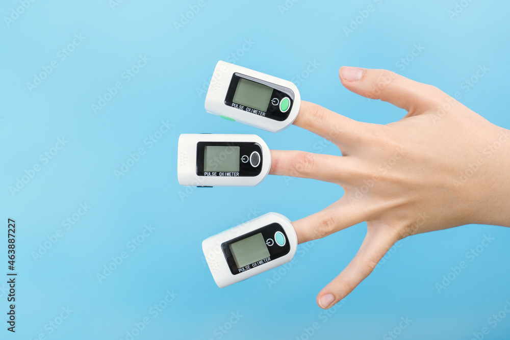 Fear of coronavirus, three pulse oximeters on a woman's palm. Fear of coronavirus, three pulse oximeters on a woman's palm.