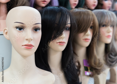 Women's wigs are put on the shelf in a wig shop.