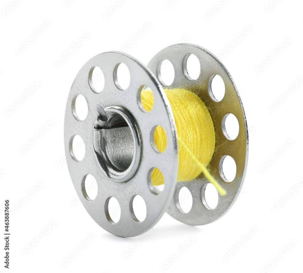 Metal spool of yellow sewing thread isolated on white Metal spool of yellow sewing thread isolated on white