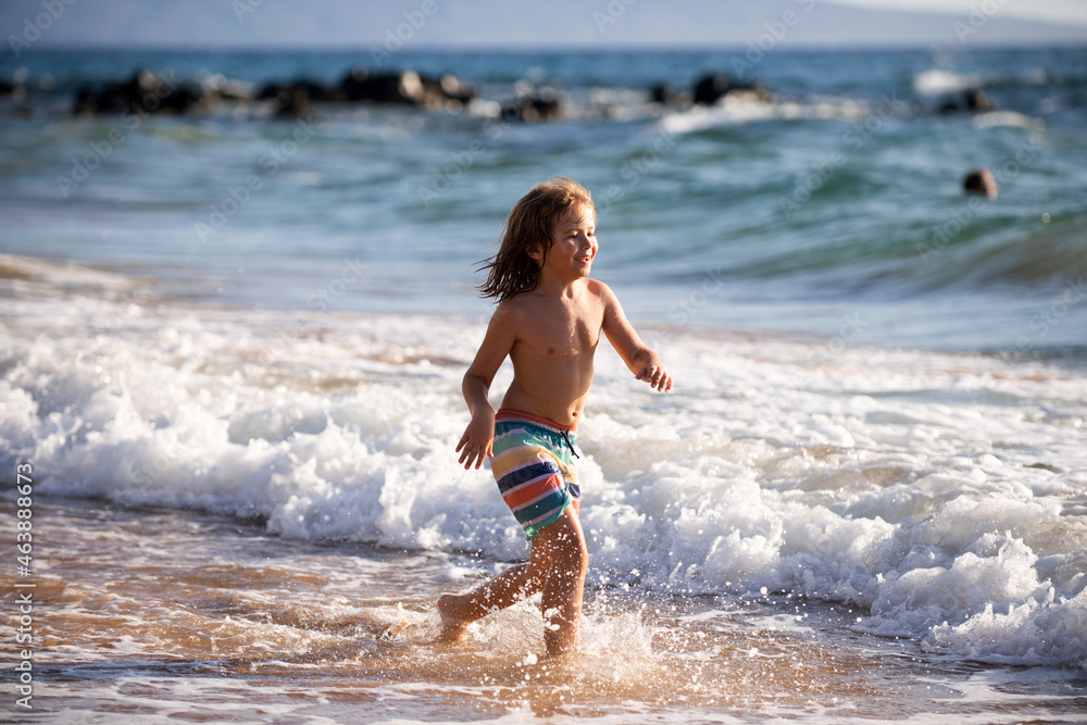 Kid running on beach. Happy child run in sea on summer vacation. Travel and adventure on sea or ocean.