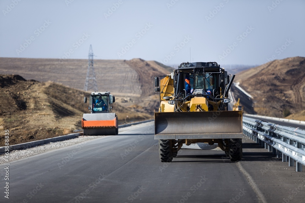 Construction site with excavator machine on on road background