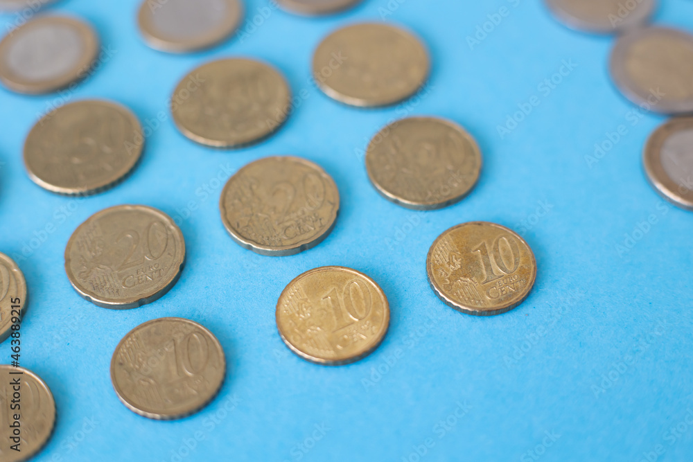 Coins on a blue background isolated Business attraction of euro money Coins on a blue background isolated Business attraction of euro money