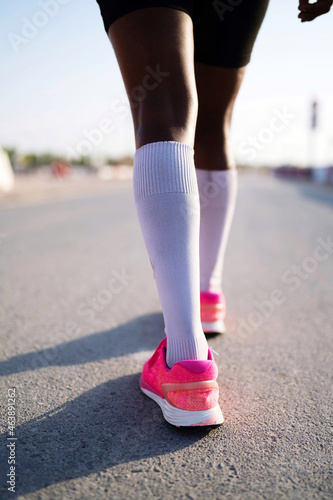 African woman walking on the road close up low angle view