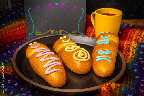 Guaguas de pan y colada morada with a blackboard sign. Typical food of Ecuador on the day of
