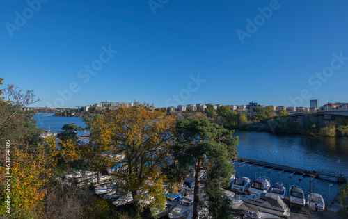 The skyline of the island Kungsholmen and piers with boats at the island Essingen an colorful autumn day in Stockholm