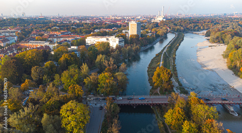 Aerial view of Isar river flowing into Munich and Thalkirchen bridge with cars in a beautiful autumn landscape © Pablo