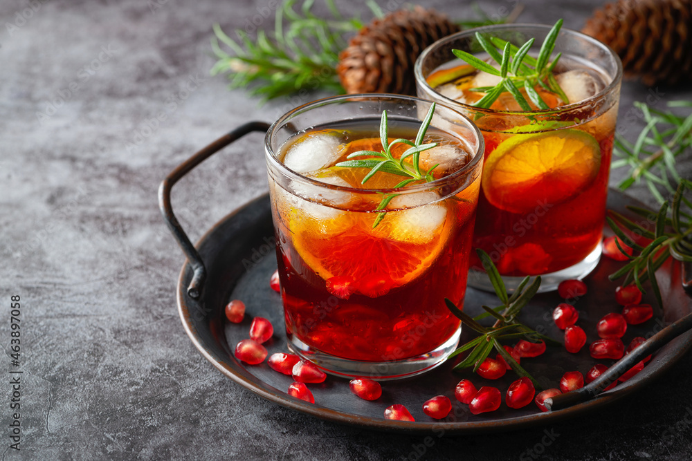 Pomegranate cocktail decorated with lime, rosemary and Ice, cold drink Pomegranate cocktail decorated with lime, rosemary and Ice, cold drink