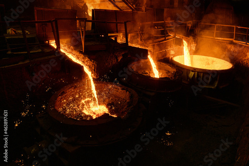 Blast furnace slag and pig iron tapping. Molten metal and slag are poured into a ladle.