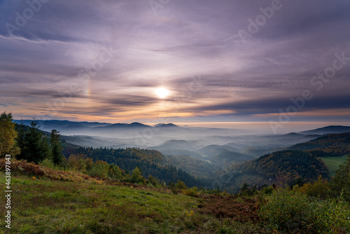 Dreamlike autumn sunset with a 22   halo and two sun dogs over the Murgtal in the northern Black Forest